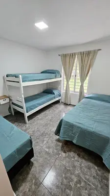 a bedroom with two beds and a window at Complejo Ebenezer in San Ignacio
