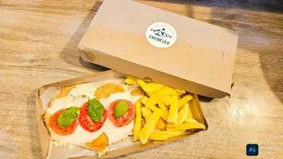 a box of pizza and french fries on a table at Complejo Ebenezer in San Ignacio