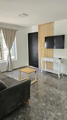 a living room with a couch and a table at Complejo Ebenezer in San Ignacio