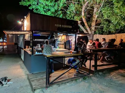 a group of people sitting at a bar at night at Casa Minimalista con Pileta Privada en el mejor lugar de Cabalango in Cavalango