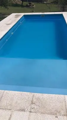 a blue swimming pool on top of a building at Casa Minimalista con Pileta Privada en el mejor lugar de Cabalango in Cavalango