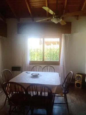 a table and chairs in a room with a window at Casa La Escondida in Villa del Dique