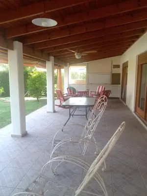 a patio with a table and chairs on it at Casa La Escondida in Villa del Dique