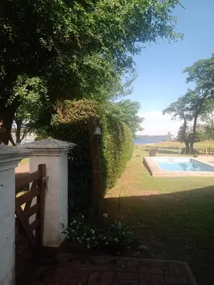 a garden with a fence and a swimming pool at Casa La Escondida in Villa del Dique