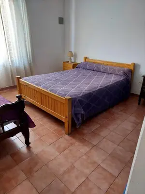 a bedroom with a bed with a purple comforter at Casa en Nono in Nono