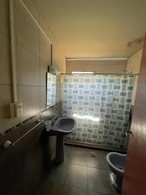 a bathroom with two toilets and a sink at Cabañas El Pela in Villa Carlos Paz