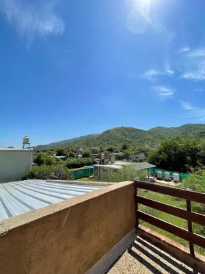 a view of the mountains from the roof of a house at Cabañas El Pela in Villa Carlos Paz