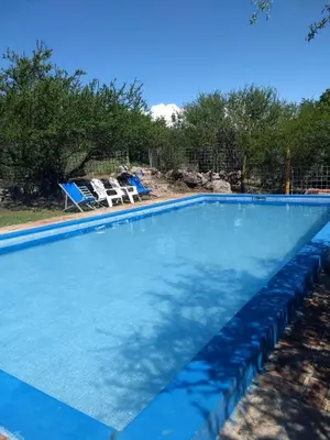 a large swimming pool with blue water at Valle Iguana in San Lorenzo