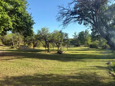 a park with a large field with trees and grass at Valle Iguana in San Lorenzo