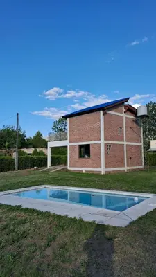 a house with a swimming pool in the yard at Lo de Abu in Villa de Las Rosas