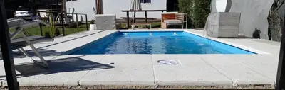 a small swimming pool in a yard with at Apartamento Jhaky in Villa Carlos Paz