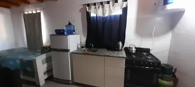 a small kitchen with a refrigerator and a stove at Apartamento Jhaky in Villa Carlos Paz