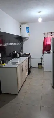 a kitchen with a sink and a stove in it at Casa Jhaky in Villa Carlos Paz