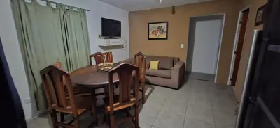 a living room with a table and chairs and a couch at Casa Jhaky in Villa Carlos Paz