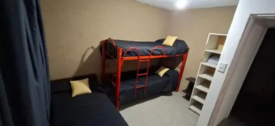 a small room with a bunk bed and a couch at Casa Jhaky in Villa Carlos Paz