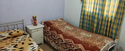 a bedroom with a bed and a chair with a blanket at El mamboreta in Pantanillo