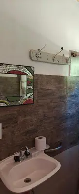 a bathroom with a sink and a mirror at El mamboreta in Pantanillo