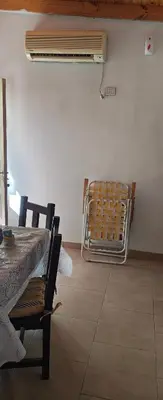 a table and chairs in a room with a heater at El mamboreta in Pantanillo