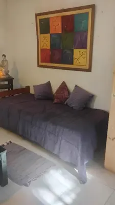 a bedroom with two beds and a painting on the wall at CASA SAMARANA Alta Gracia in Alta Gracia