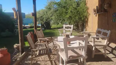 a group of white chairs sitting in a yard at CASA SAMARANA Alta Gracia in Alta Gracia