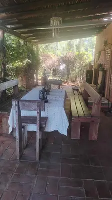 a picnic table and benches on a patio at CASA SAMARANA Alta Gracia in Alta Gracia