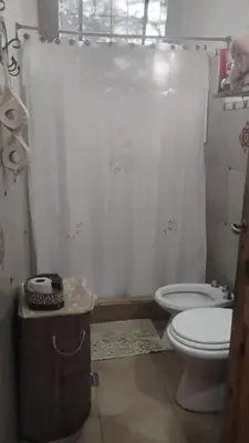 a bathroom with a toilet and a shower curtain at CASA SAMARANA Alta Gracia in Alta Gracia