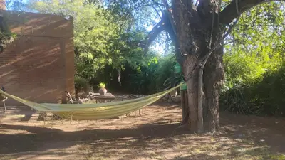a hammock tied to a tree next to a tent at CASA SAMARANA Alta Gracia in Alta Gracia