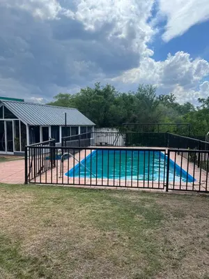 a swimming pool with an iron fence around it at Departamento en Villa Carlos paz in Villa Carlos Paz