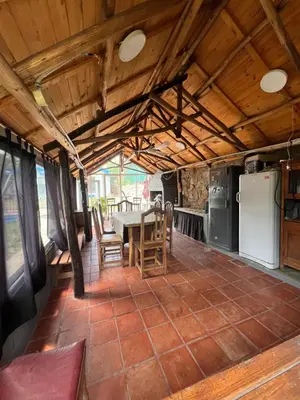 a kitchen with a table and chairs in a room at Departamento en Villa Carlos paz in Villa Carlos Paz