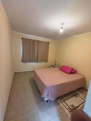 a bedroom with a pink bed and a window at Quique1 in Pilar