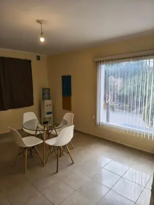 a dining room with a table and chairs and a window at Quique1 in Pilar