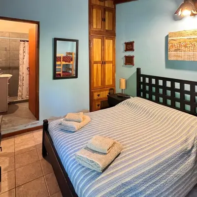 a bedroom with a bed with two towels on it at Casa completa con piscina a 600 metros de plaza de Villa de las Rosas in Villa de Las Rosas