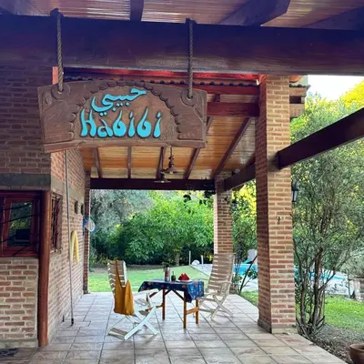a patio with a table and chairs on it at Casa completa con piscina a 600 metros de plaza de Villa de las Rosas in Villa de Las Rosas