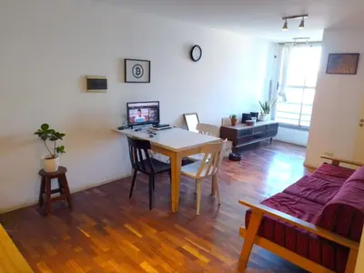 a living room with a table and a couch at S rosa centro in Cordoba