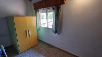 a yellow refrigerator in a room with a window at El Balcón de la Costanera in Santa Rosa de Calamuchita