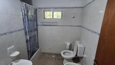 a bathroom with a toilet and a shower at El Balcón de la Costanera in Santa Rosa de Calamuchita