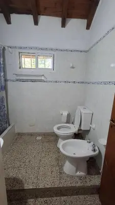 a bathroom with a toilet and a window at El Balcón de la Costanera in Santa Rosa de Calamuchita