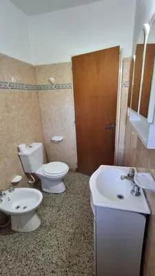 a bathroom with a toilet and a bidet and a sink at El Balcón de la Costanera in Santa Rosa de Calamuchita