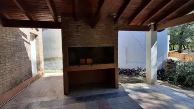 a fireplace on a patio with a brick wall at El Balcón de la Costanera in Santa Rosa de Calamuchita
