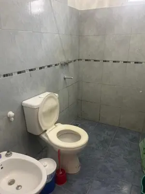 a bathroom with a toilet and a sink at Cabañas el atardecer de Andrés - Flor Serrana - Tanti in Tanti