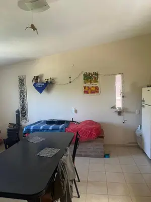 a bedroom with a bed and a table in a room at Cabañas el atardecer de Andrés - Flor Serrana - Tanti in Tanti
