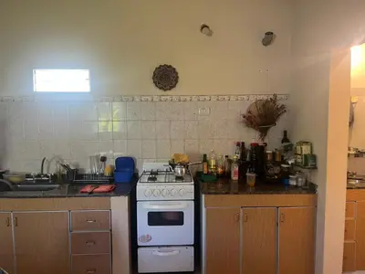 a kitchen with a stove and a counter top at Cabañas el atardecer de Andrés - Flor Serrana - Tanti in Tanti