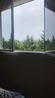 a window in a bedroom with a view of trees at Cabañas el atardecer de Andrés - Flor Serrana - Tanti in Tanti