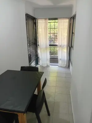 a dining room with a black table and chairs at Nueva Córdoba primer piso Externo in Cordoba