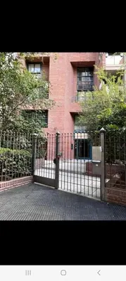 a black gate in front of a brick building at Nueva Córdoba primer piso Externo in Cordoba