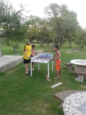 a group of children playing a game on a table at Alto de Balcón in Tanti