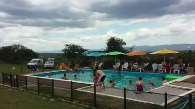 a group of people in a swimming pool at Alto de Balcón in Tanti