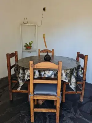 a table with two chairs and a lamp on it at La Armonía Departamentos in Merlo