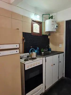 a kitchen with a stove with a tea kettle on it at La Armonía Departamentos in Merlo