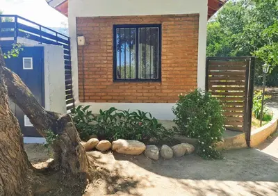 a house with a fence and a window at La Armonía Departamentos in Merlo
